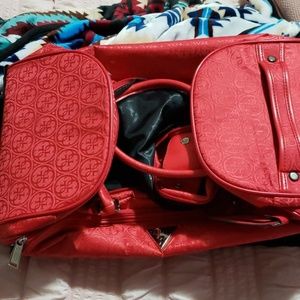 Guess red luggage bag